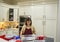 Korean woman in her kitchen apron preparing Thanksgiving dinner in Edmond, OKlahoma.