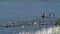 Korean women fishing for mollusks near shore of shallow river