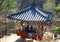 Korean wooden pavilion in the shade of trees