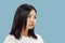 Korean young woman`s half-length portrait on blue background