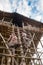 Korowai tribe people at a ladder to the Traditional Koroway house perched in a tree above the ground,