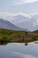 Koruldi Lake -  A horse at a lake with view on the mountain ridges in Upper Svaneti, Caucasus, Georgia.