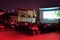 Kosovars and foreign visitors take their seats on a raised platform to watch a documentary film during Dokufest in Prizren