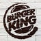 Kostanay, Kazakhstan, 11-25-2018, Burger King logo painted on a brick wall in a restaurant. Opening day. Popular fast food item