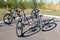 Kostanay, Kazakhstan, 2019-10-06. Four bicycles stand on pavement near young autumn trees. Mass ride cyclists. The concept and