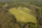 KOSZALIN, POLAND - 30 MARCH 2019 - Aerial view on grass ruined football stadium hidden in deep forest at Gora Chelmska close to