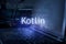 Kotlin inscription against laptop and code background. Technology concept. Learn programming language