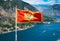 Kotor. Bay of Kotor on the background of the flag of Montenegro. Kotor fortress