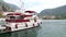 Kotor, Montenegro - 27 June, 2017. Captain of yacht is an elderly man sitting at table and reading tablet. Beautiful