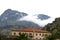 Kotor, a town on the Montenegrin coast. Mountains in the fog and a stone building.