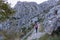 Kotor - Woman with backpack on idyllic hiking trail from Kotor to Derinski Vrh, Lovcen mountains, Dinaric Alps, Montenegro