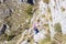 Kotor - Woman with backpack on idyllic via ferrata hiking trail from Kotor to Derinski Vrh, Montenegro