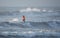 Kovalam, Chennai, Tamilnadu, India - â€Žâ€ŽAugust 9th â€Ž2021: Young boy Indian surfer surfing and practicing on the beach waves