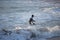 Kovalam, Chennai, Tamilnadu, India - â€Žâ€ŽAugust 9th â€Ž2021: Young boy Indian surfer surfing and practicing on the beach waves