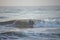 Kovalam, Chennai, Tamilnadu, India - â€Žâ€ŽAugust 9th â€Ž2021: Young boy Indian surfer surfing and practicing on the beach waves