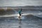 Kovalam, Chennai, Tamilnadu, India - â€Žâ€ŽAugust 9th â€Ž2021: Young boy Indian surfer surfing and practicing on the beach waves