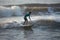 Kovalam, Chennai, Tamilnadu, India - â€Žâ€ŽAugust 9th â€Ž2021: Young boy Indian surfer surfing and practicing on the beach waves