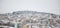 Kozani, Greece. Traditional snowy town and misty sky background. Panoramic view.