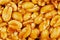Kozinaki from golden, roasted peanuts beans as a background, texture. Macro shooting, close-up. Place for text