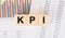 KPI word written on wood block. Faqs text on table, concept