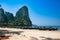 Krabi province, Railay beach, Thailand - February 18, 2019: Long-tailed taxi boats stand in a row on Ao Nang beach. Tourists on