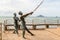 Krabi Thailand July 2018. Bronze statue of marlin, a pair of sailors fishes a sword against the background of Ao Nang beach