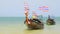 Krabi, Thailand - March 2019: Thai long tail wooden boats rocking on the waves near Railay beach