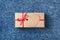 Kraft gift box with red bow and tag.