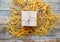 Kraft gift box on wooden table with raffia or twine