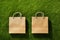 Kraft paper sale bags on green grass. Green friday, sustainable consumption, sustainability, zero waste and sale concept. Copy