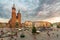 Krakow main square and St. Mary gothic church in the old town, Poland at sunset with stormy clouds. Aerial view