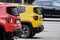 Krakow, Poland 05.01.2019: two SUV Jeep cars in the Parking lot red and yellow, rear side view, rear parts, bright city cars