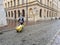 Krakow, Poland - 5 7 2019. A young man will ride down the street of the old town with tourist suitcases on wheels. Near Grodskaya