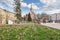 KRAKOW,POLAND - APRIL 11, 2018: Beautiful spring flower bed and old tenements in Podgorze district