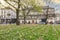 KRAKOW,POLAND - APRIL 11, 2018: Beautiful spring flower bed and old tenements in Podgorze district