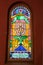 Krakow, POLAND - April, 2019: Multi-colored window stained glass inside the Jewish synagogue. Image of minors and two lions.
