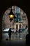 Krakow, Poland - February 23, 2016: View of old Krakow in rainy evening through the archway, Krakow, Poland