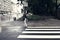 Krakow, Poland - July 18, 2020: A wide angle shot of zebra patterns on a street of Europe and a female crossing the road