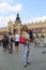 Krakow, Poland - June 11, 2018: Beautiful girl holding tired daughter in market  square of Krakow. concept of traveling with kids