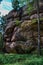 Krasnoyarsk pillars, nature park in Siberia. large geometric stone red rocks overgrown with light green yellow moss in light