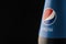 Krasnoyarsk, Russia February 23, 2020: Pepsi-fragment of the brand label on the bottle close-up on a black background