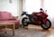 KRASNOYARSK, RUSSIA - March 6, 2019: Red and black sportbike Honda CBR 600 RR 2005 PC37 in house. The motorcycle in the apartment