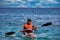 Kreta or Crete  Greece - A man in life jacket floating on a kayak in a sea against clouds. Water sport kayaking during summer