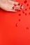 Krill oil capsules .omega fatty acids.Flying gelatin krill oil capsules in a hand on a red background. Natural