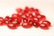 Krill oil red gelatin capsules on a white wooden background .omega fatty acids.Natural supplements and vitamin