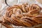 Kringle or pretzel traditional Christmas dessert in Northern Europe with cinnamon closeup on the paper. Horizontal