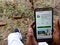 Krishi network app displayed on digital screen holded hand mobile phone at village area in india dec 2019