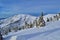 Krkonose mountains covered with snow, frozen trees. The highest peak Snezka in the background