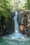 Kroya waterfall in Sambangan mountain area on Bali island. The pools with crystal clear water under the rocky wall