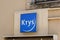 Krys blue optic logo and text sign front of optician shop glasses store